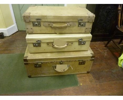 Two vintage vellum suitcases, together with a further vellum trunk with brass fittings (3)