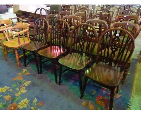 A set of four modern stained beechwood Windsor style hoop and stick back dining chairs with central pierced wheel splats