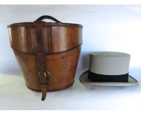 A good quality antique stitched and tanned leather hat box of usual form with belted lid, stamped to front and bearing label 