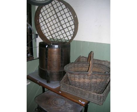 A vintage wooden and steel banded bushel, two wicker baskets of varying design, an old garden sieve of  circular form, and a 