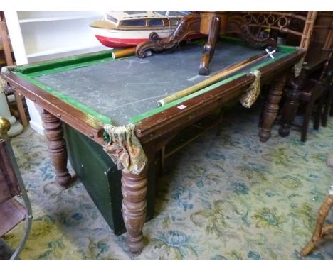 A vintage snooker table with slate bed, mahogany frame, raised on four turned and tapered legs (stamped to framework Riley, A