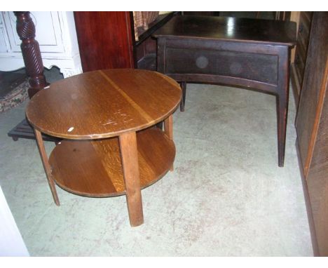 A stained oak Arts & Crafts style occasional table of rectangular form, with moulded panelled frieze with inverted folding pa