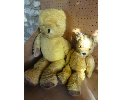 Two vintage teddy bears with inset glass eyes and padded paws