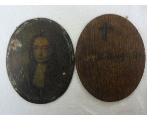 An early 18th century miniature portrait on copper of oval form showing a bust length portrait of a young gentleman with long