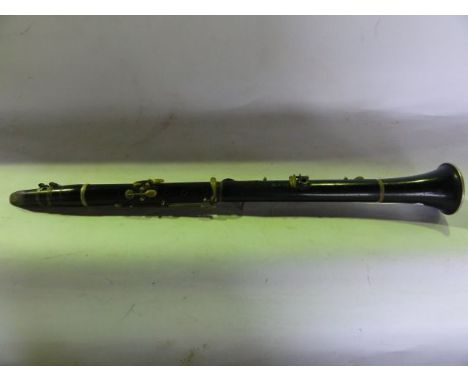 An old clarinet with ebonised timber composition with metallic mounts, 56 cm long approx