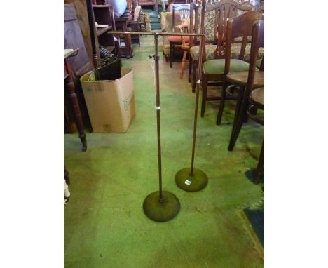 A pair of small vintage anodised floorstanding shop display stands with telescopic adjustable T bars raised on simple turned 