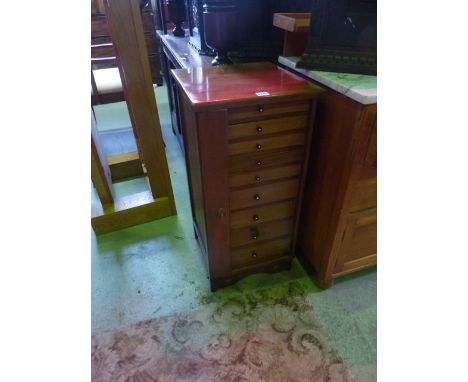 A small vintage collectors cabinet fitted with nine graduated shallow drawers with single locking mechanism, 75 cm high x 36.