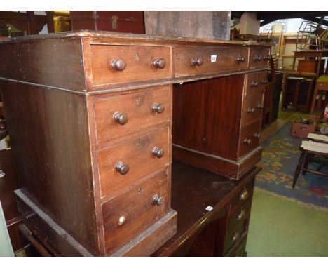 A Victorian mahogany and stained pine kneehole twin pedestal desk of rectangular form with faux inset panelled top over the u