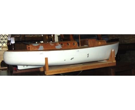 A vintage home built timber pond launch with internal motor, for completion (displayed amongst the furniture alongside lot 11