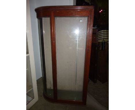 A vintage mahogany framed/faced freestanding shop display cabinet with single D end and enclosed by a rectangular glazed pane