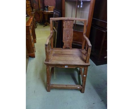 A vintage Chinese elbow chair with stripped pine frame, the back with central shaped and carved splat over a solid seat raise