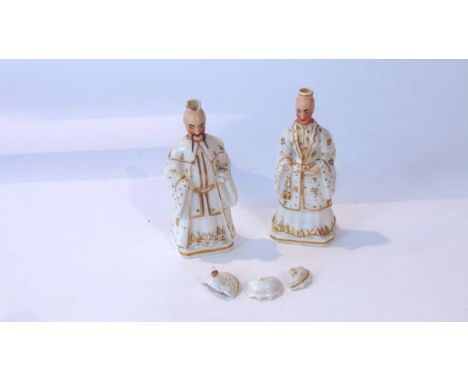 A pair of 19th century white glazed ceramic flasks in the form of male and female characters in oriental style costume, and w