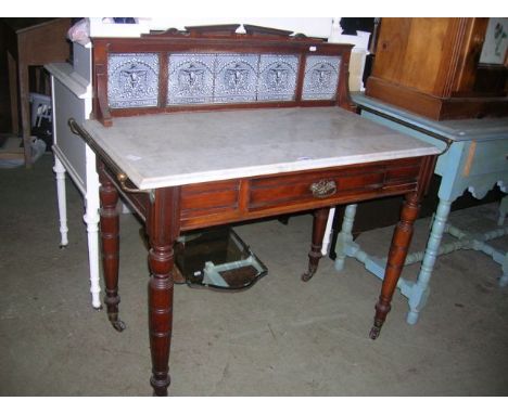 A late Victorian/Edwardian walnut marble top washstand of rectangular form, the raised back/splashback incorporating a frieze