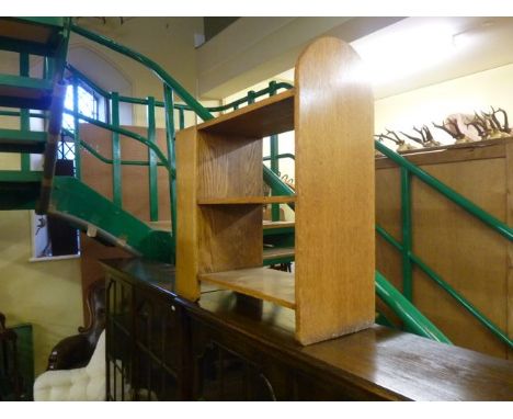 An Art Deco oak open book shelf/divider on three tiers, 63 cm long, labelled P E Gane Limited