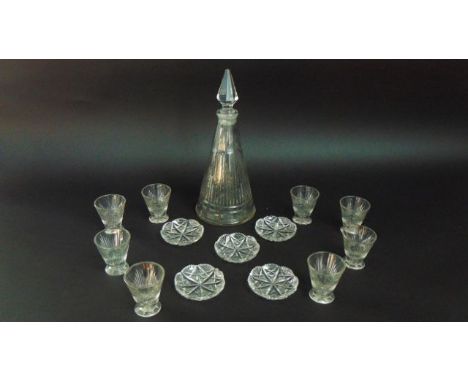 A heavy cut glass steeple shaped decanter, 8 conical shaped shot glasses and five pin trays