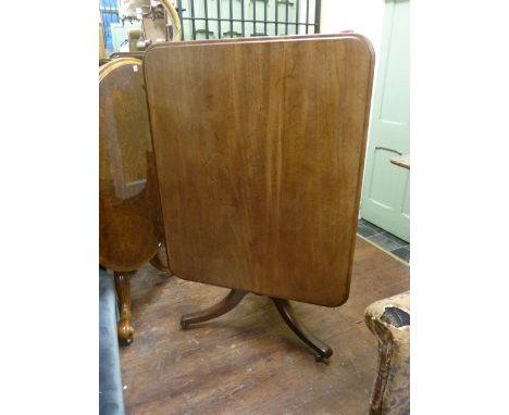 A mid-19th century mahogany breakfast table, the rectangular top raised on a turned pillar and tripod base