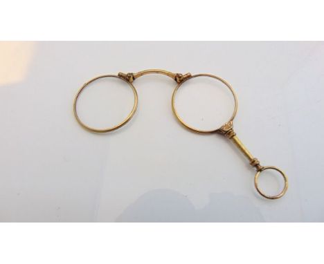 A gold-plated lorgnette, with engine-turned and floral details