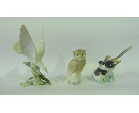 A Lladro model of a pair of swallows, a Lladro Daisa group of a dove on a flowering branch and a Nao model of an owl