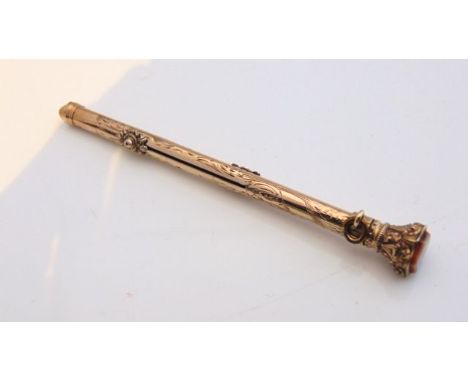 A Victorian gold-plated propelling pencil and dip pen, engraved with floral details, terminating with a shield-shaped hardsto