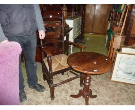 A 19th century oak ladder back elbow chair with rush seat in the Georgian manner, together with a provincial occasional table