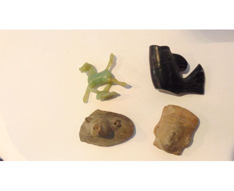 A pottery fragment with relief moulded grotesque animal head together with a further terracotta model of the head of a male c
