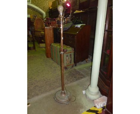 A vintage copper telescopic standard lamp with simple turned column, stepped disc shaped platform base and paw feet, together