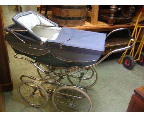A vintage Silver Cross coach built pram with blue painted livery, folding frame, spoke wheels and hard rubber tyres
