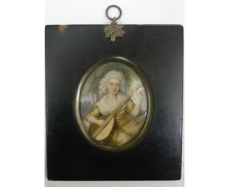 A late 18th century miniature portrait of oval form showing a young woman in yellow dress playing a lute in a landscape setti