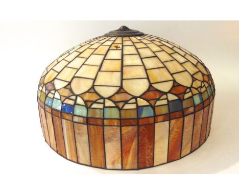 A substantial ceiling light shade composed in leaded glass panels in shades of blue, amber, cream, etc