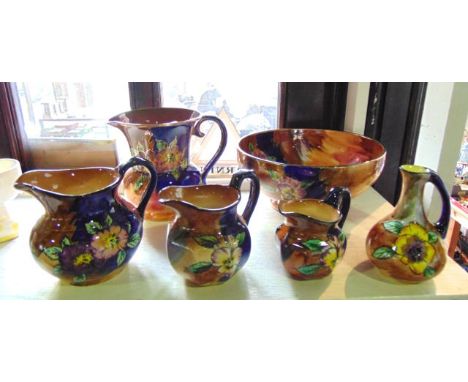 A collection of H & K Tunstall Viola pattern wares comprising a circular bowl and five jugs of various design