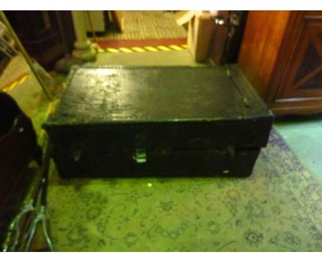 A vintage steel banded and leather clad cabin trunk with partially fitted interior
