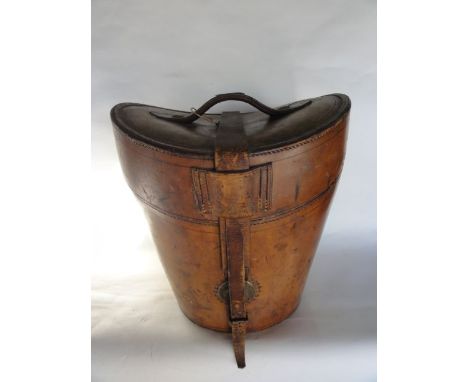 A substantial good quality vintage stitched and tanned leather top hat box with belted lid revealing a quilted interior with 
