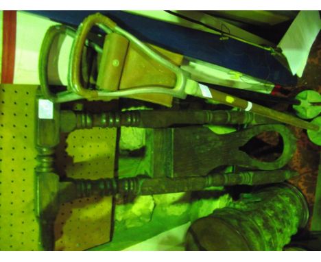 A vintage oak boot jack with partially turned frame, together with two shooting sticks