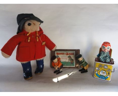 An assortment of vintage toys to include a Paddington Bear in red felt coat, a boxed golfing game Toppit and Slicer, a vintag