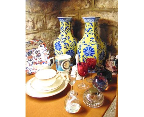 A pair of yellow ground oriental ceramic vases with foliate and floral detail in shades of blue, a pair of small wine glasses