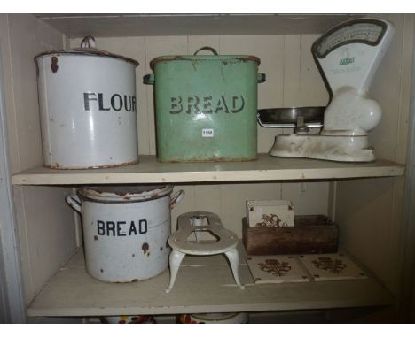 Two vintage enamel bread bins of cylindrical and rectangular form, one cream, one green, both complete with lids, a further e