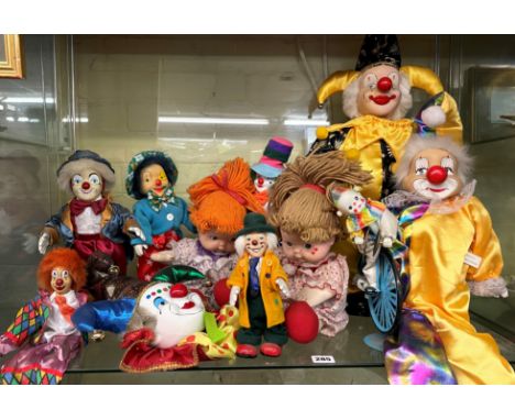 SHELF OF PORCELAIN HEADED CLOWN FIGURES AND DOLLS