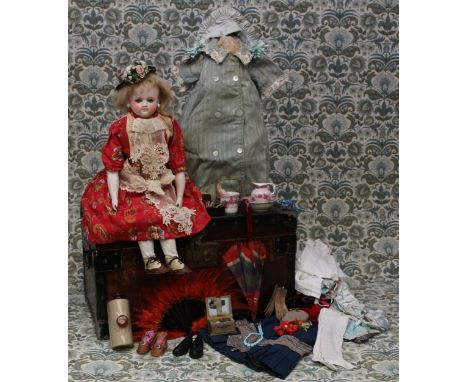 A 19th century pale bisque shoulder head French Poupée de Mode or fashion doll, the bisque head inset with fixed blue glass e