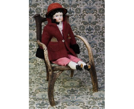 A late 19th century glazed china shoulder head doll, the glazed head with black moulded hair, painted features including blac