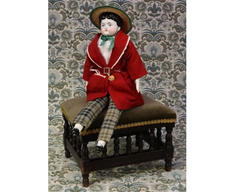 A 19th century glazed china shoulder head doll, the glazed head with moulded black hair, painted features including black eye