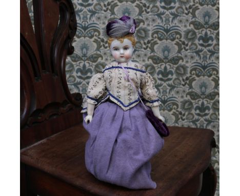 A 19th century glazed china shoulder head doll, the glazed head with moulded brown hair, painted features including brown eye
