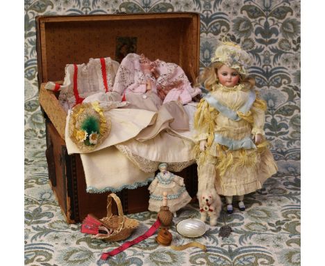A late 19th century bisque shoulder and bisque head doll, of small proportions, the bisque head inset with fixed blue glass e
