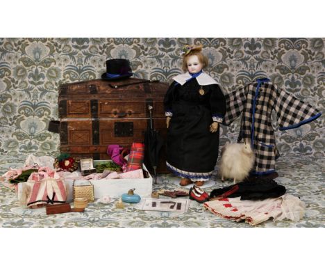 A 19th century pale bisque shoulder and bisque head French Poupée de Mode or fashion doll, the bisque head inset with fixed b