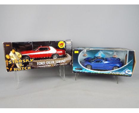 Ertl, Solido - Two boxed 1:18 scale diecast model cars. Lot consists of Ertl 'American Muscle' Starksy &amp; Hutch Ford Gran 