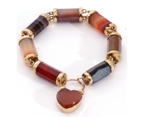 Scottish agate bracelet comprising seven various cylindrical banded agate faceted links, capped and joined by yellow metal fi