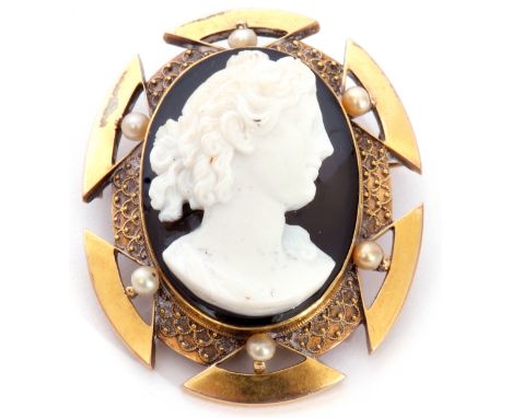 Victorian oval hardstone cameo brooch depicting a head and shoulders profile of a Bacchanalian lady, carved in high relief on
