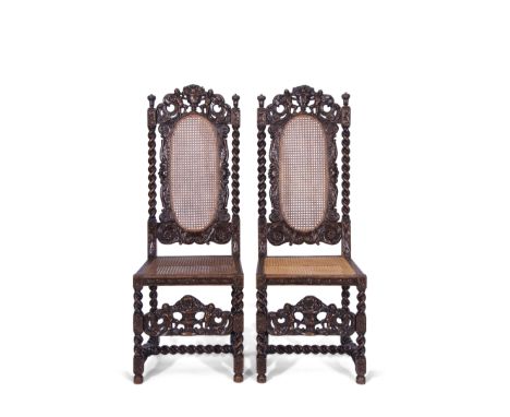 Pair of 19th century stained oak standard chairs in Carolean style, cresting rails featuring two cherub and scroll carvings w