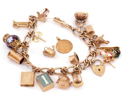 A 9ct gold curb link chain suspending various 9ct gold charms to include enamelled medieval knight on horseback, a glass and 