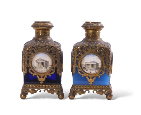 Two Palais Royale gilt metal mounted glass square scent bottles with pierced sleeves and caps inset with coloured prints of P