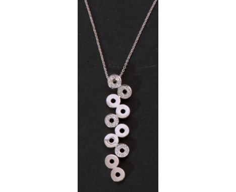 Modern stylised articulated diamond set pendant necklace, a design featuring ten pierced discs, four highlighted with small d